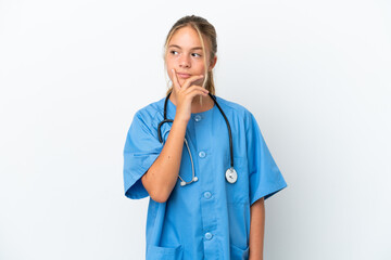 Little caucasian girl disguised as surgeon isolated on white background having doubts and with confuse face expression