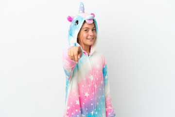 Little girl with unicorn pajamas isolated on white background points finger at you with a confident expression