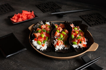 Trendy Hybrid Food Sushi Tacos with salmon, rice and edamame beans.