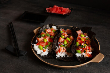 Trendy Hybrid Food Sushi Tacos with salmon, rice and edamame beans.
