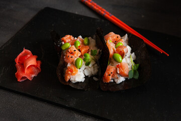 Trendy Hybrid Food Sushi Tacos with salmon, rice and edamame beans.