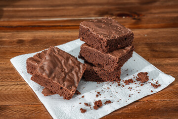 Stack of Homemade chocolate brownie squares on a table.