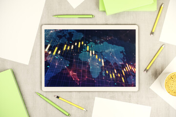 Top view of abstract financial diagram with world map on modern digital tablet monitor, banking and accounting concept. 3D Rendering