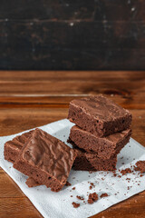 Homemade chocolate brownie squares on a table. Vertical orientation. Copy space
