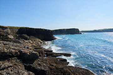 Cliffs with deep blue sea and clear skies
