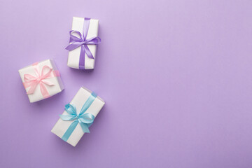 Colorful gift boxes on color background, top view