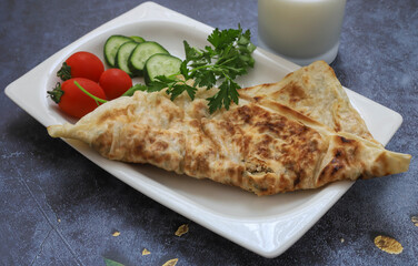 Traditional Turkish food, Turkish flatbread with cheese and herbs. Turkish pancake concept.