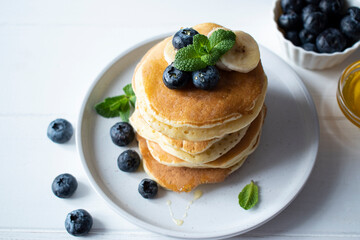 breakfast - pancakes with blueberries, banana and honey