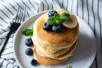 pancakes with blueberries, banana and honey