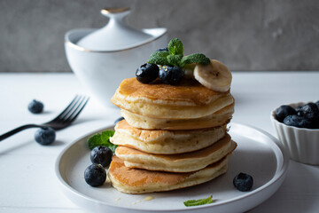 breakfast - pancakes with blueberries, banana and honey