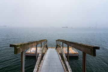 A Private dock on a gloomy and foggy lake