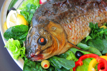 dish of fried fish with herbs and vegetables.