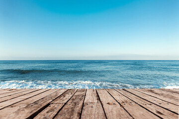 Old boards, floor against the background of the blue sea and sky. The concept of vacation, travel, vacation, wallpaper.