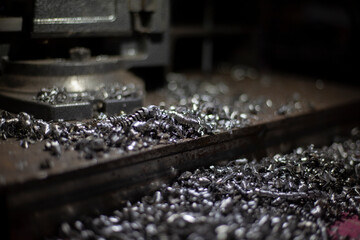 Metal shavings. Production waste. Steel chips after drilling. Garbage in workshop.