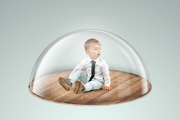 Child safety, overprotection, a little boy sits under a glass dome, cap. Vaccinations, protection...