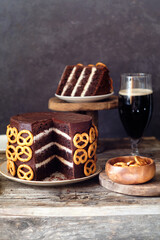 Beer chocolate cake. Pretzels. Guinness. Side view. wooden background.