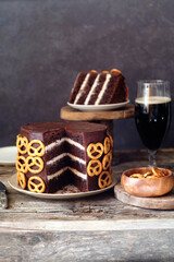 Beer chocolate cake. Pretzels. Guinness. Side view. wooden background.