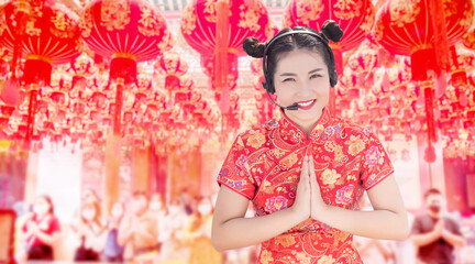 Asian in red Chinese dress Show greetings and headsets for Chinese temple