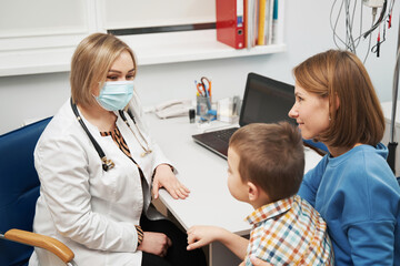 Woman and little boy having appointment with pediatrician