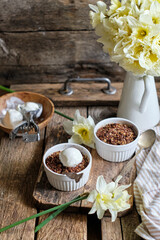 Crumble with apple and chocolate. Narcissus, ice cream, wood background, side view, vensa.