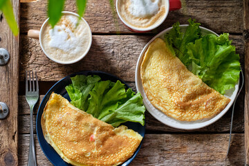 Breakfast. Omelette. Lettuce, coffee.