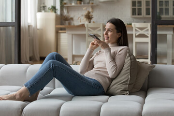 Positive beautiful smartphone user woman in casual having telephone call on speaker, giving voice...