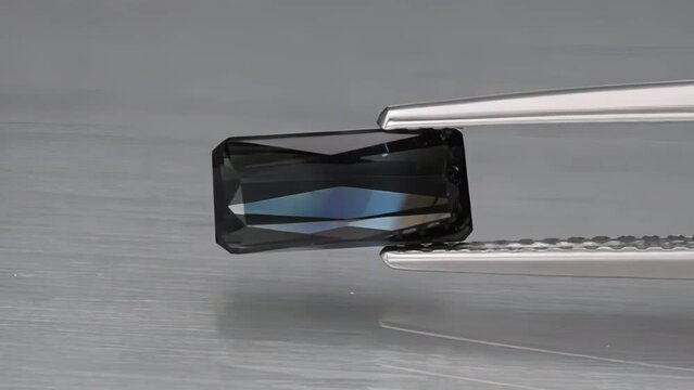 natural blue tourmaline indicolite baguette in the tweezers