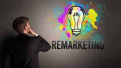 businessman drawing colorful light bulb