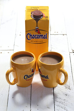 WIEHL, GERMANY - APRIL 3, 2022: pair of Chocomel mugs with chocolate-flavored milk on wooden background