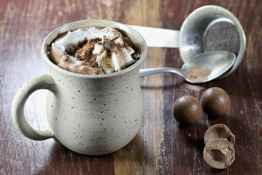 hot chocolate drink in a fictile mug on wooden background