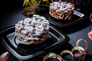 Traditional Finnish cuisine: Funnel cakes with powdered sugar topping are eaten around May 1st with...