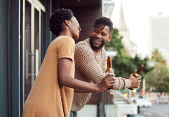 Love makes every moment extra special. Shot of an affectionate your couple drinking beer while bonding on a balcony outdoors.