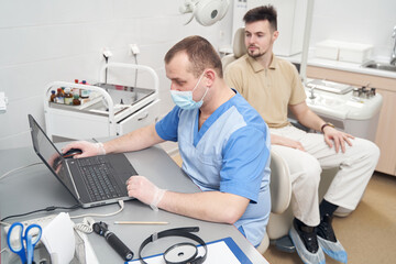 Man during consultation in doctor modern office