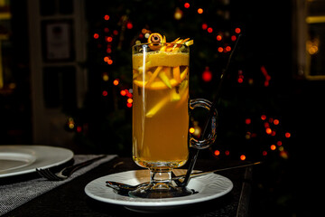 Orange grog in a tall glass stands on the bar - obrazy, fototapety, plakaty