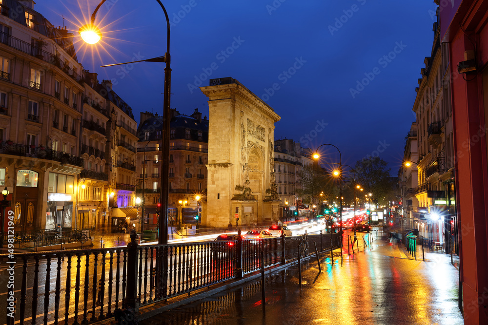 Wall mural porte saint-denis at rainy night . it is a parisian monument located in the 10th arrondissement of p