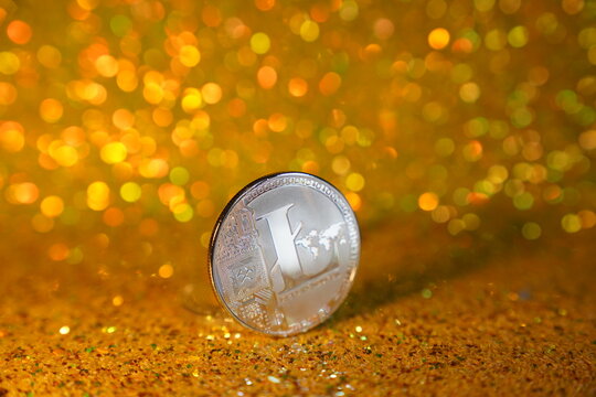 One litcoin coin. Litcoin cryptocurrency is the coin of the future. Golden shiny background. High quality photo