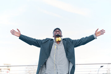 man smiling arms raised up to blue sky, celebrating freedom. Positive human emotions, face expression feeling life perception success, peace of mind concept. Free Happy man with suit enjoying nature