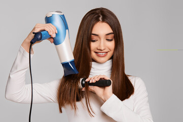 attractive cheerful lady drying strong healthy hair