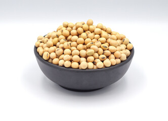 soybean seeds in a wooden bowl isolated on white background