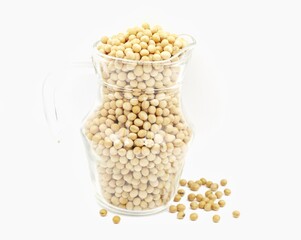 Close-up of soybean seeds in a clear glass jar isolated on white background