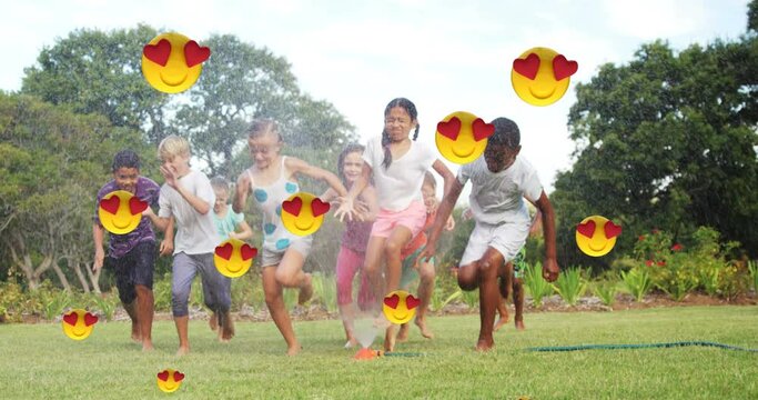 Animation of falling love emoji over happy diverse children