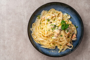 homemade fettuccine pasta with white cream sauce. fettuccine Carbonara made with eggs, hard cheese, cured pork, and black pepper. Italian food. - obrazy, fototapety, plakaty
