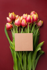 Gift craft box mockup Empty craft box on top of beautiful tulip bouquet