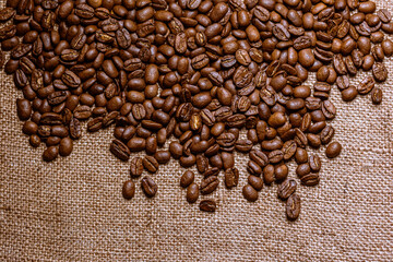 Roasted coffee beans with burlap background