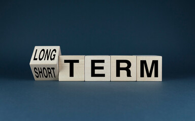 Cubes form words of choice Long term or short term. Concept of business investment and goals