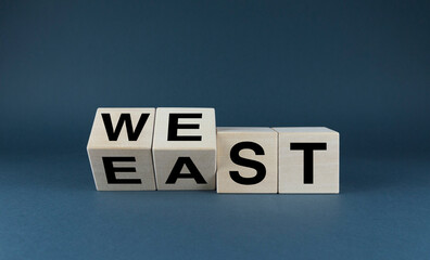 East vs west. Cubes form words east or west.