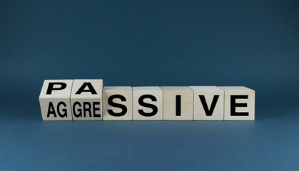 Passive or Aggressive Behavior. The cubes form the choice words Passive or Aggressive.
