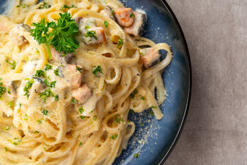homemade fettuccine pasta with white cream sauce. fettuccine Carbonara made with eggs, hard cheese, cured pork, and black pepper. Italian food.
