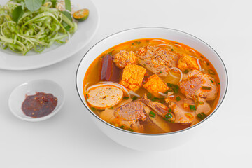 Bun Rieu Cua, Crab paste vermicelli soup with minced shrimp, tofu, tomato, shrimp paste, Vietnamese food isolated on white background, close up