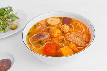 Bun Rieu Cua, Crab paste vermicelli soup with minced shrimp, tofu, tomato, shrimp paste, Vietnamese food isolated on white background, close up